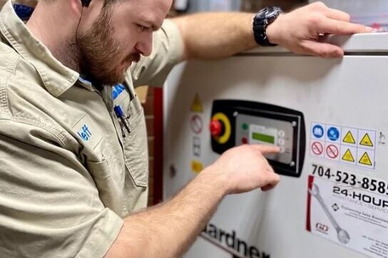 Man servicing Gardner Denver equipment