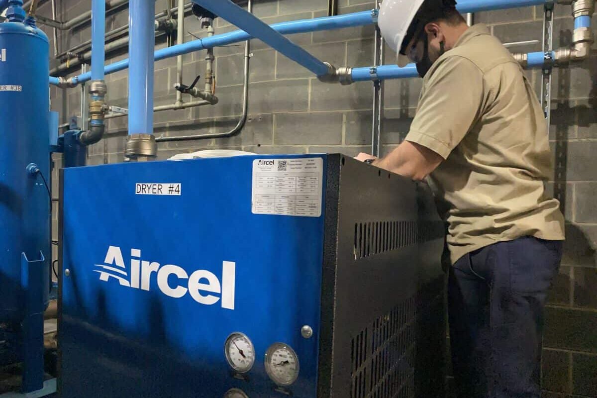 worker servicing an industrial machine