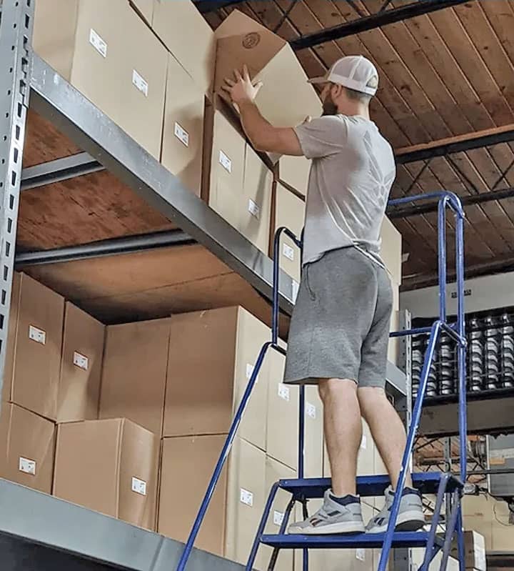 Person removing a box in a warehouse