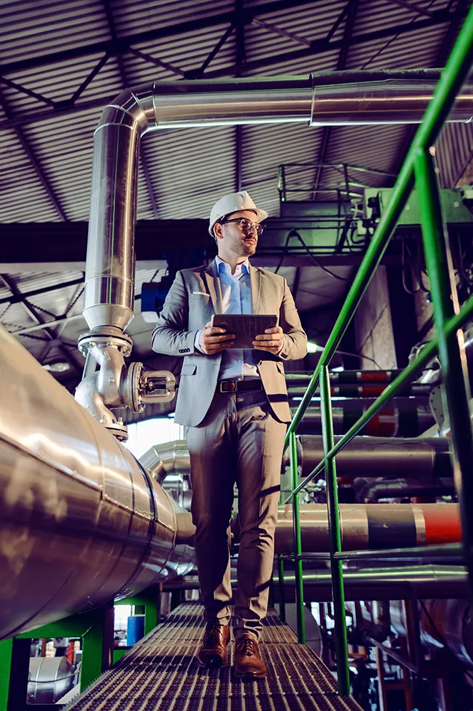 pipeline worker walking near pipes