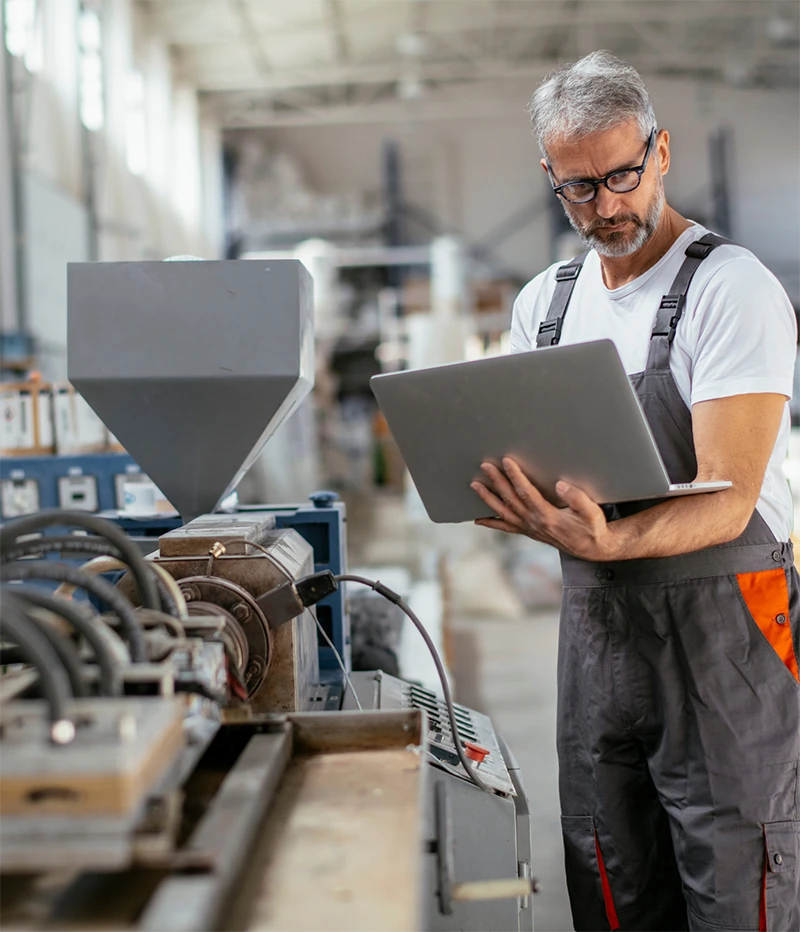 industrial worker looking at a laptop
